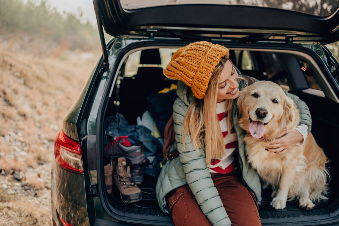 TURPIT banner displaying a woman sitting in the trunk area of a SUV with a dog